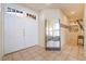 Bright foyer featuring tile flooring, a large mirror, and views of the living room at 8225 Taos Paseo Ave, Las Vegas, NV 89128