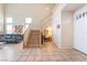 Open-concept foyer featuring a staircase, tile flooring, and a two story ceiling at 8225 Taos Paseo Ave, Las Vegas, NV 89128