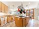Spacious kitchen with an island, granite countertops, and modern hanging pot rack at 8225 Taos Paseo Ave, Las Vegas, NV 89128