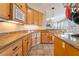 Bright kitchen features granite counters, wood cabinets and stainless steel appliances at 8225 Taos Paseo Ave, Las Vegas, NV 89128