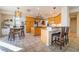 Open concept kitchen features a central island, breakfast bar, and light-colored cabinets at 8225 Taos Paseo Ave, Las Vegas, NV 89128