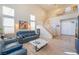 Spacious living room featuring hardwood floors, a staircase and a two-story ceiling at 8225 Taos Paseo Ave, Las Vegas, NV 89128