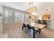 Open living room with fireplace, plantation shutters, and view to breakfast area and kitchen at 8225 Taos Paseo Ave, Las Vegas, NV 89128