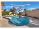 A serene private pool surrounded by lush landscaping and hardscape, offering a tranquil retreat with mature trees at 8225 Taos Paseo Ave, Las Vegas, NV 89128