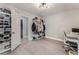 Spacious bedroom featuring closet organizer, desk, light gray walls, and wood-look flooring at 8348 Brittany Harbor Dr, Las Vegas, NV 89128