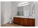 Bathroom featuring dual sinks, a wooden vanity, and a large mirror offers functionality at 8805 Jeffreys St # 2002, Las Vegas, NV 89123