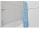 Clean white bathtub and shower combination are equipped with a stylish shower curtain at 8805 Jeffreys St # 2002, Las Vegas, NV 89123