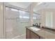 Bathroom with a tiled shower, glass door, and granite vanity with a rectangular basin at 9563 Grapeland Ave, Las Vegas, NV 89148