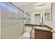 Bathroom featuring a shower with glass doors, toilet, and vanity with granite countertop at 9563 Grapeland Ave, Las Vegas, NV 89148