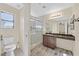 Well-lit bathroom featuring a tiled shower, wood-look floors and modern vanity at 9563 Grapeland Ave, Las Vegas, NV 89148
