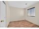 Bedroom featuring wood-look floors and a bright window with blinds at 9563 Grapeland Ave, Las Vegas, NV 89148