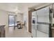 Bright kitchen with stainless steel refrigerator, breakfast nook, and sliding glass door to patio at 9563 Grapeland Ave, Las Vegas, NV 89148