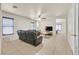 Spacious living room with neutral tile floors, ceiling fan and dark leather sofa set at 9563 Grapeland Ave, Las Vegas, NV 89148