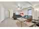 Open living room with neutral tile floors, bright walls, stairs, and comfortable leather sofa set at 9563 Grapeland Ave, Las Vegas, NV 89148