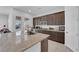 Modern kitchen with granite countertops, stainless steel appliances, and dark wood cabinets at 9590 Smiley Creek St, Las Vegas, NV 89178