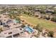 Aerial view of a luxury home near a golf course, with a sparkling pool and spa in the backyard at 11473 Glowing Sunset Ln, Las Vegas, NV 89135
