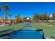 Outdoor basketball court with vibrant blue and green playing surface and well-maintained surroundings at 11473 Glowing Sunset Ln, Las Vegas, NV 89135