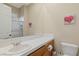 Powder room with decorative art, toilet and white sink set in a vanity at 11473 Glowing Sunset Ln, Las Vegas, NV 89135