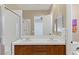 Bathroom boasting double sinks, a shower, decorative art and a toilet at 11473 Glowing Sunset Ln, Las Vegas, NV 89135
