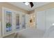 Neutral bedroom featuring carpet, doors to the outside and a ceiling fan at 11473 Glowing Sunset Ln, Las Vegas, NV 89135