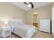 Cozy bedroom with ensuite bath, featuring a white color palette and a ceiling fan at 11473 Glowing Sunset Ln, Las Vegas, NV 89135