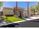 Beautiful desert home with a stone facade and manicured lawn, complemented by lush palm trees at 11473 Glowing Sunset Ln, Las Vegas, NV 89135