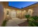 Inviting front entrance with double doors, complemented by desert landscaping and neutral color palette at 11473 Glowing Sunset Ln, Las Vegas, NV 89135