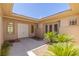 The entrance to the home is bright and sunny, surrounded by desert vegetation at 11473 Glowing Sunset Ln, Las Vegas, NV 89135