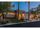 Beautiful home exterior with stone archway, three-car garage and manicured front yard with palm trees at 11473 Glowing Sunset Ln, Las Vegas, NV 89135