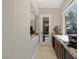 Hallway features granite countertops, custom cabinetry, and views to both the front and side yards at 11473 Glowing Sunset Ln, Las Vegas, NV 89135