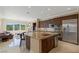 Open-concept kitchen with granite island, stainless appliances, and view into the living room at 11473 Glowing Sunset Ln, Las Vegas, NV 89135