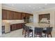Gourmet kitchen with granite countertops, stainless steel appliances, and custom dark wood cabinetry at 11473 Glowing Sunset Ln, Las Vegas, NV 89135