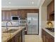 Close-up of kitchen featuring stainless steel appliances, granite countertops, and custom cabinetry at 11473 Glowing Sunset Ln, Las Vegas, NV 89135