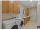 Laundry room features cabinets for storage, appliances and a utility sink at 11473 Glowing Sunset Ln, Las Vegas, NV 89135