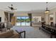 Bright living room with comfortable seating and a view of the backyard pool at 11473 Glowing Sunset Ln, Las Vegas, NV 89135