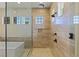 Large shower with three windows allows lots of natural light in this remodeled bathroom at 11473 Glowing Sunset Ln, Las Vegas, NV 89135