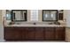 Bathroom features and sinks with dark wood cabinets and granite countertops at 11473 Glowing Sunset Ln, Las Vegas, NV 89135