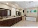 Bright bathroom with and sinks, a stand alone soaking tub, and a seamless glass shower at 11473 Glowing Sunset Ln, Las Vegas, NV 89135