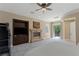 Comfortable and inviting, this bedroom offers a fireplace, tv cabinet, and access to a balcony at 11473 Glowing Sunset Ln, Las Vegas, NV 89135