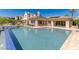 Beautiful backyard pool featuring a baja shelf and spa, with an attached covered patio for outdoor entertaining at 11473 Glowing Sunset Ln, Las Vegas, NV 89135
