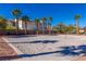 Sand volleyball court situated near palm trees, offering a recreational amenity for residents at 11473 Glowing Sunset Ln, Las Vegas, NV 89135