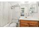 Cozy bathroom featuring a tub with shower, white shower curtain, toilet and sink with wooden vanity at 1381 E University Ave # 301, Las Vegas, NV 89119