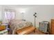 Cozy bedroom with patterned bedding, a wooden bench, and neutral walls at 1381 E University Ave # 301, Las Vegas, NV 89119