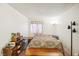 Bright bedroom featuring a patterned bedspread, a wooden bench, and personal storage at 1381 E University Ave # 301, Las Vegas, NV 89119