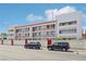 Street view of an apartment building with red accents and secure wall at 1381 E University Ave # 301, Las Vegas, NV 89119