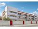 Apartment building featuring balconies and a privacy wall, with a red roof and red trim at 1381 E University Ave # 301, Las Vegas, NV 89119