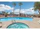 Apartment pool area with mature palm trees and a sunny sky at 1381 E University Ave # 301, Las Vegas, NV 89119