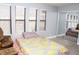 This bedroom features natural light from three windows and a mirrored closet for extra space and style at 2080 Karen Ave # 21, Las Vegas, NV 89169
