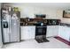 Bright kitchen with stainless steel appliances, ample cabinet space, and tile flooring for easy maintenance at 2080 Karen Ave # 21, Las Vegas, NV 89169