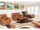 A living room featuring an area rug, neutral paint, and three windows at 2080 Karen Ave # 21, Las Vegas, NV 89169